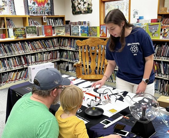 Physics Minor Sydney Kinsella performs magic tricks to demonstrate physics concepts to children at the New Hartford Public Library on November 8, 2025.