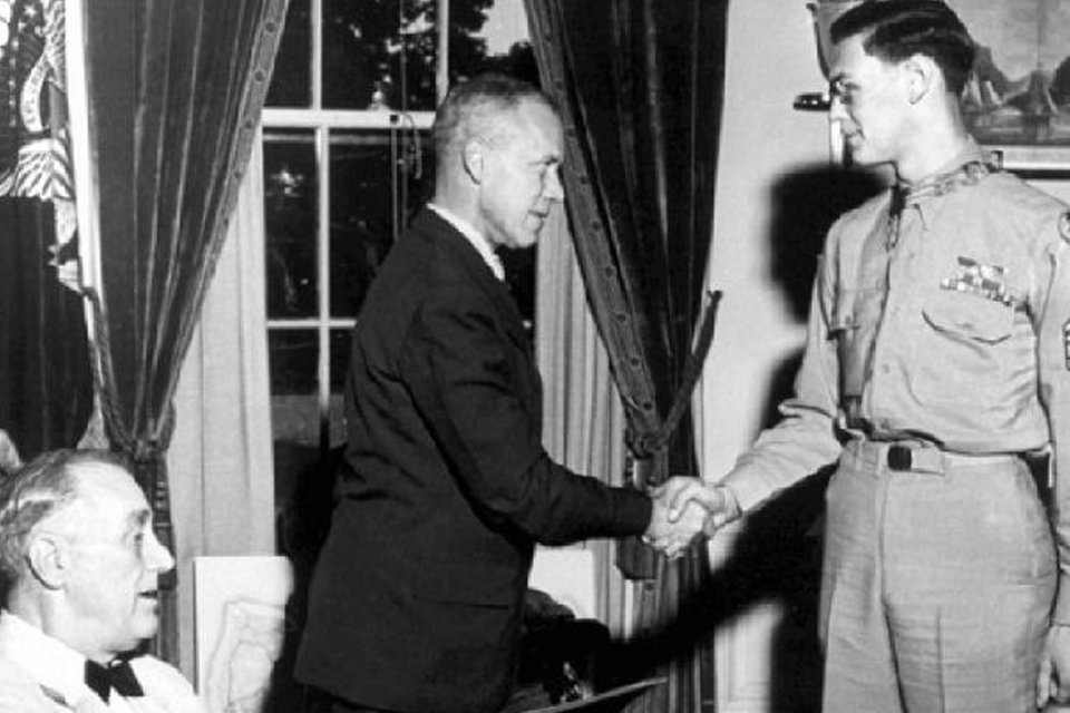 Black and white image of Forrest Vosler receving medal from President Franklin Delano Roosevelt.